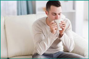 A man drinks mint tea, wanting to cure erectile dysfunction. 